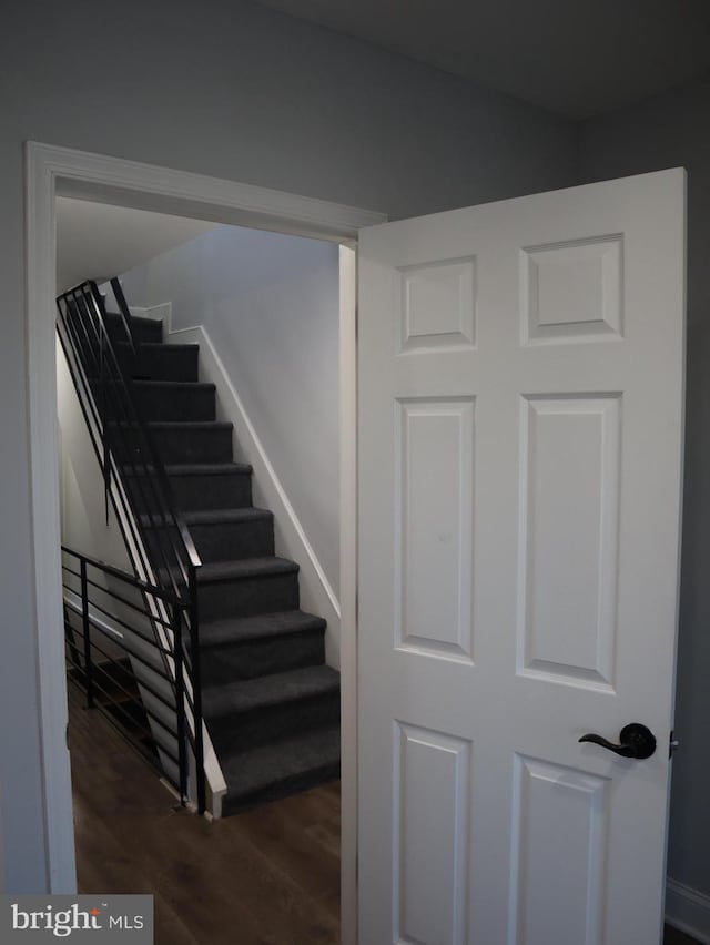 stairs featuring wood-type flooring