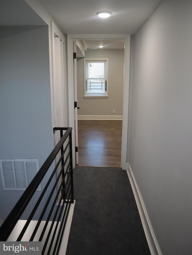 corridor with dark wood-type flooring