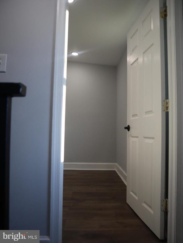 corridor with dark wood-type flooring