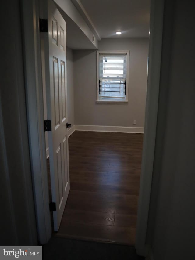 spare room with dark wood-type flooring