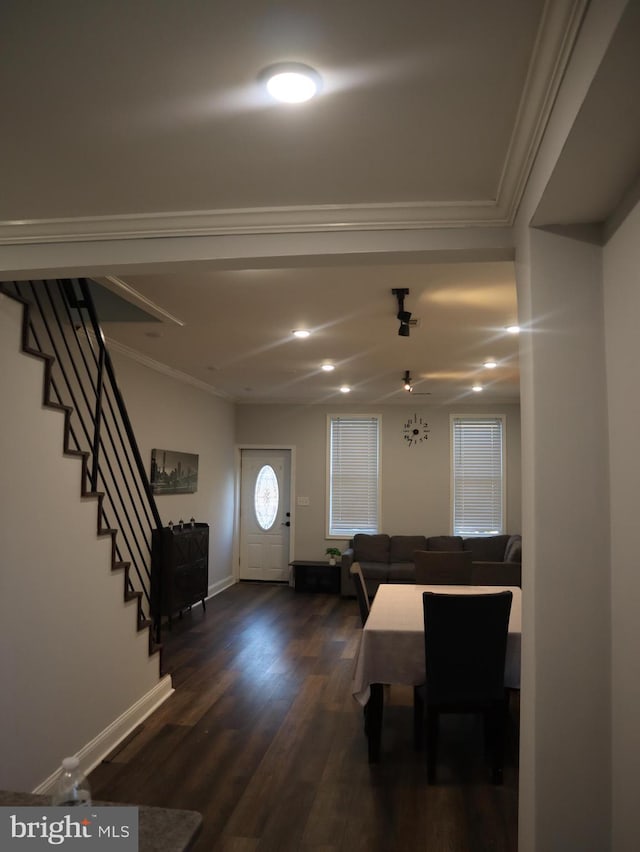 entryway with crown molding and dark wood-type flooring