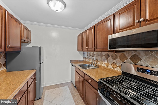 kitchen with decorative backsplash, sink, crown molding, appliances with stainless steel finishes, and light tile patterned floors