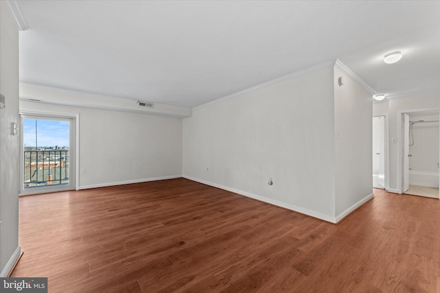 spare room featuring hardwood / wood-style floors and ornamental molding