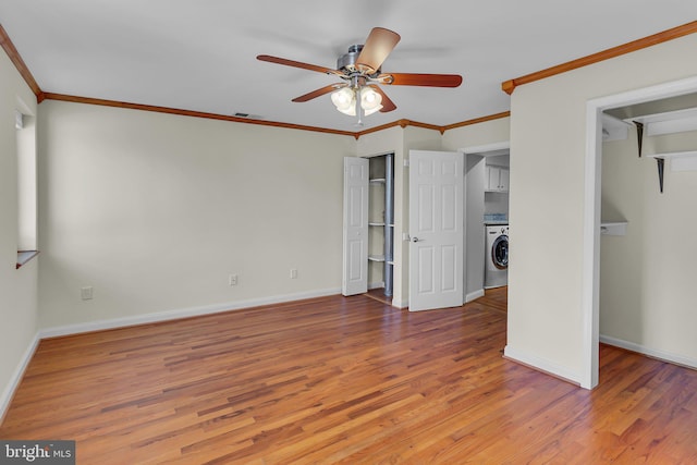 unfurnished bedroom featuring washer / clothes dryer, ceiling fan, ornamental molding, and hardwood / wood-style flooring