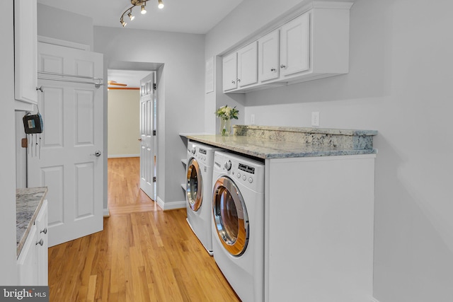 washroom featuring cabinets, washing machine and dryer, light hardwood / wood-style floors, and ceiling fan