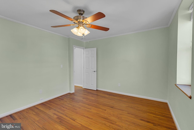 spare room featuring crown molding, ceiling fan, and wood-type flooring