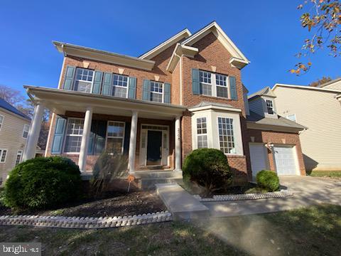 view of front of home with a porch and a garage