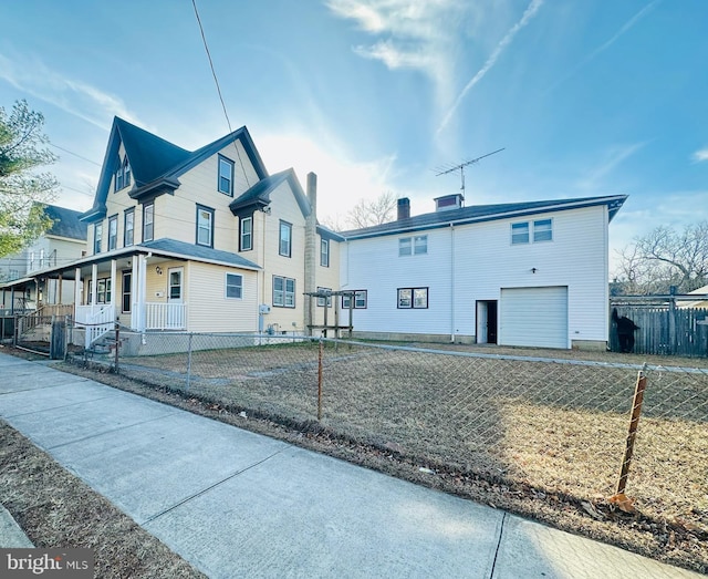 view of side of property featuring a garage and a porch