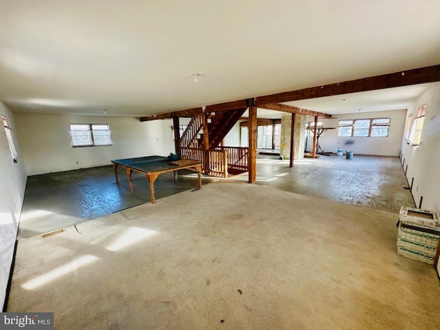 rec room featuring beam ceiling and plenty of natural light