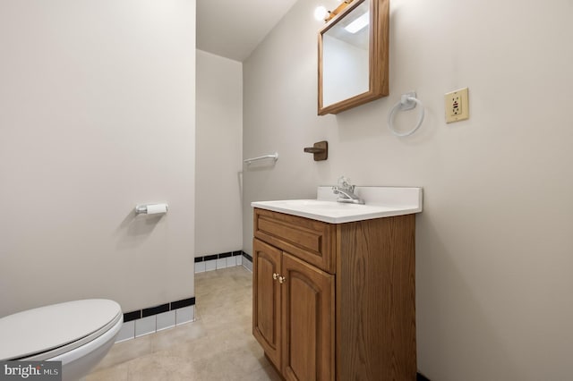 bathroom featuring toilet, vanity, and tile patterned flooring