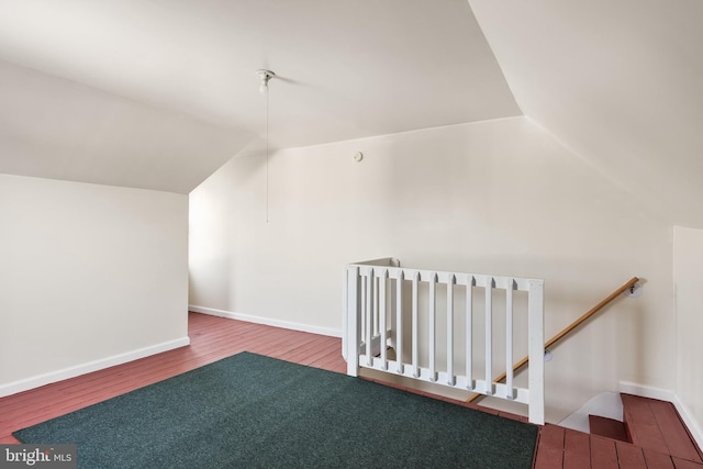 bonus room with lofted ceiling and wood-type flooring