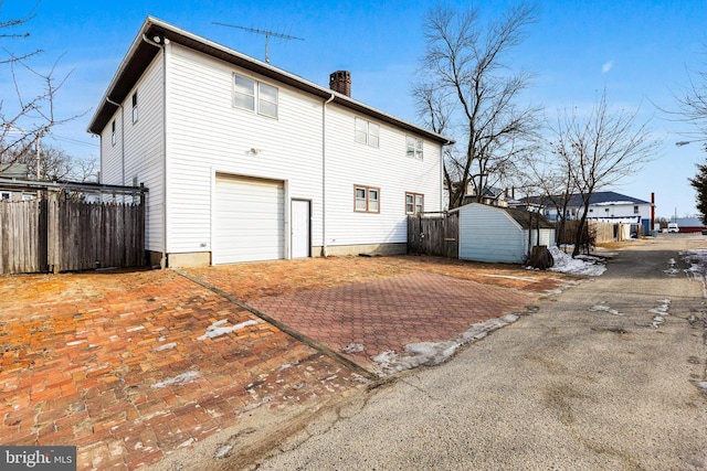 rear view of house with a garage