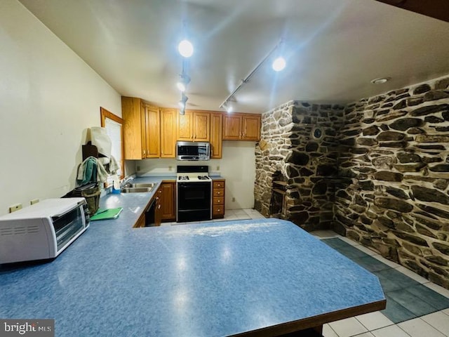 kitchen featuring white electric range, rail lighting, kitchen peninsula, and sink