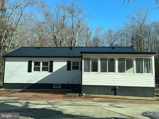 view of side of property with a sunroom