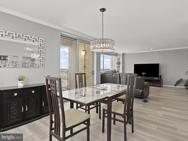 dining room with light hardwood / wood-style flooring and crown molding