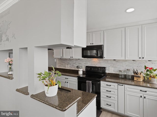 kitchen featuring black appliances, white cabinets, dark stone countertops, and tasteful backsplash