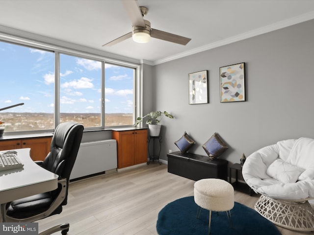 office area with ceiling fan, ornamental molding, and light hardwood / wood-style flooring