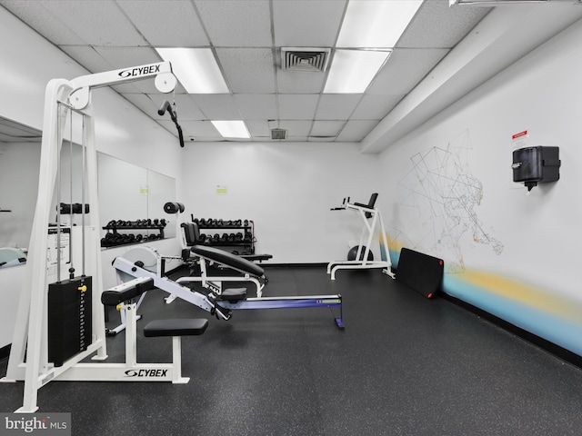 exercise room featuring a paneled ceiling