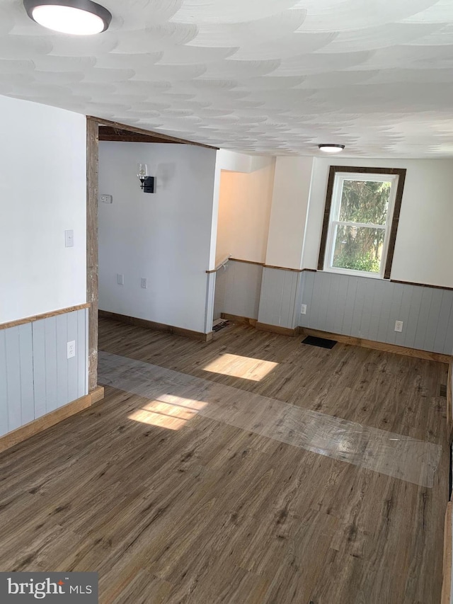 empty room with dark hardwood / wood-style floors