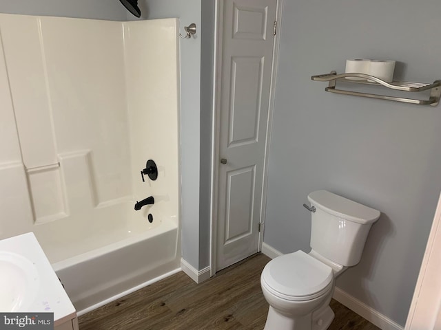 full bathroom featuring wood-type flooring, toilet, vanity, and bathing tub / shower combination