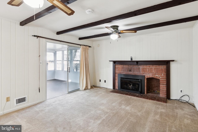 unfurnished living room with carpet floors, a fireplace, visible vents, ceiling fan, and beamed ceiling