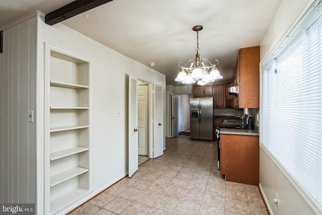 kitchen featuring built in shelves, a notable chandelier, range with electric stovetop, stainless steel fridge with ice dispenser, and decorative light fixtures