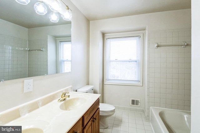 bathroom featuring tile patterned flooring, toilet, vanity, visible vents, and baseboards