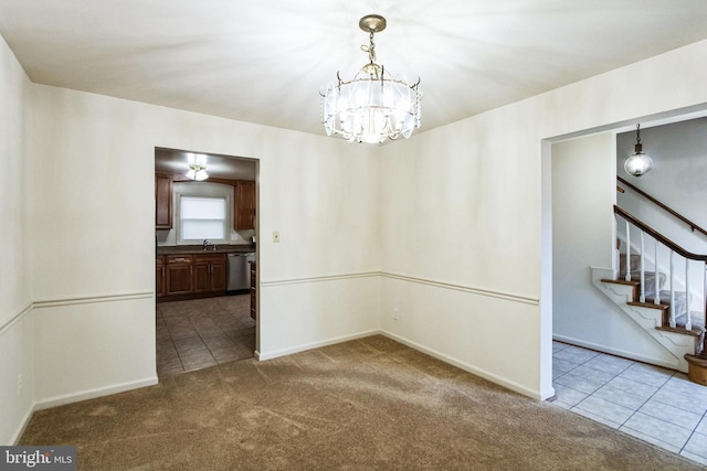 unfurnished dining area with dark carpet, stairway, an inviting chandelier, a sink, and dark tile patterned floors