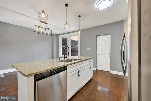 kitchen featuring sink, light stone counters, decorative light fixtures, appliances with stainless steel finishes, and white cabinets