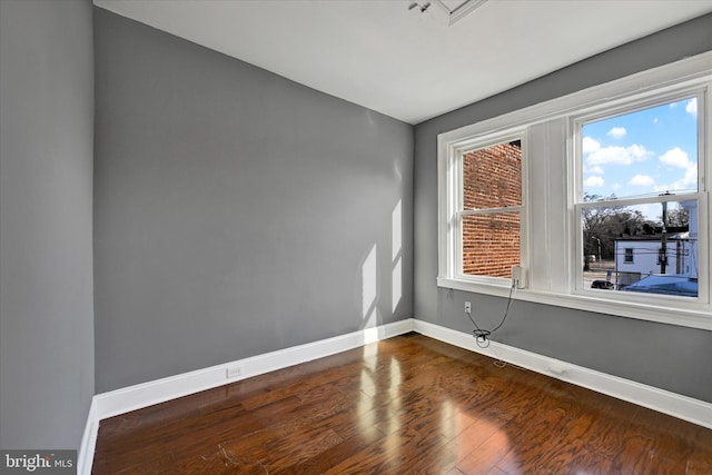 unfurnished room with hardwood / wood-style flooring