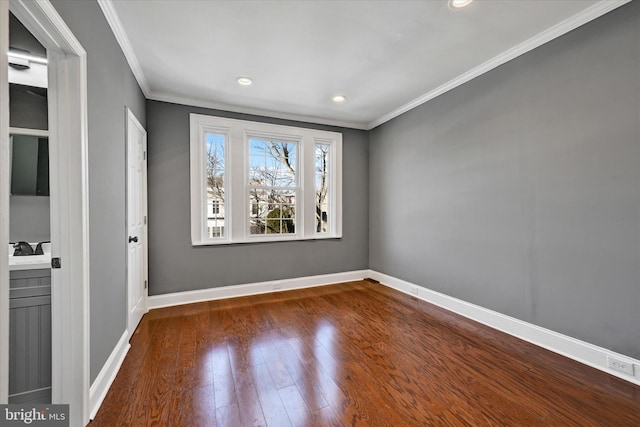 spare room featuring crown molding and dark hardwood / wood-style floors