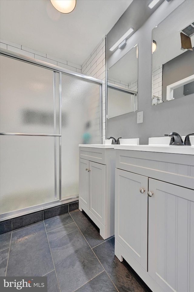 bathroom with walk in shower and vanity