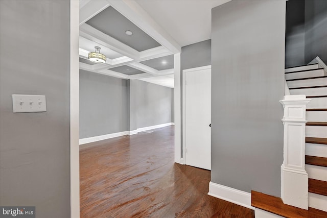 hallway with coffered ceiling, beam ceiling, and dark hardwood / wood-style floors