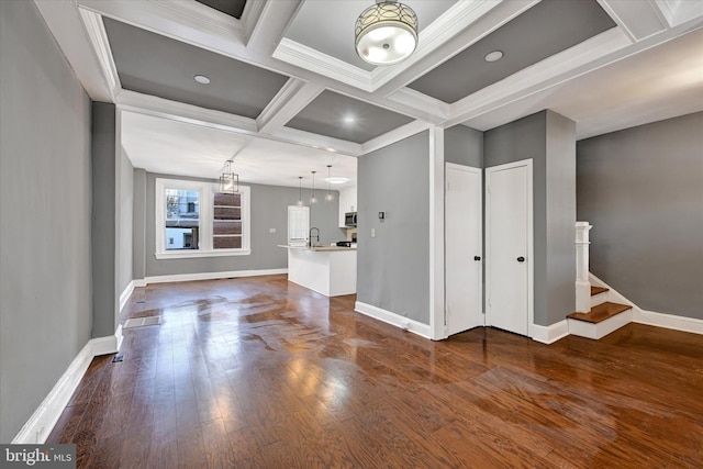 unfurnished living room with coffered ceiling, beam ceiling, ornamental molding, and dark hardwood / wood-style floors