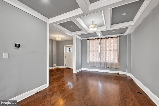 unfurnished room with wood-type flooring, ornamental molding, coffered ceiling, and beam ceiling