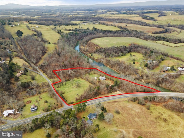 birds eye view of property with a rural view