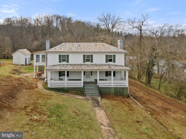 farmhouse with a porch and a front yard