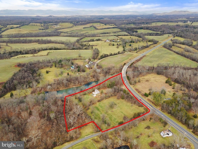 birds eye view of property featuring a mountain view and a rural view