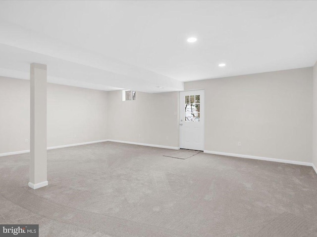 below grade area featuring recessed lighting, light carpet, and baseboards