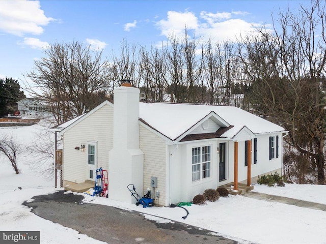 view of front of house featuring a chimney