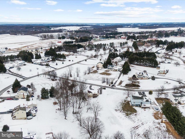 snowy aerial view with a residential view