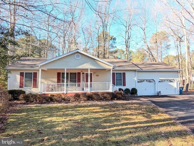 view of front of property featuring a garage and a front lawn