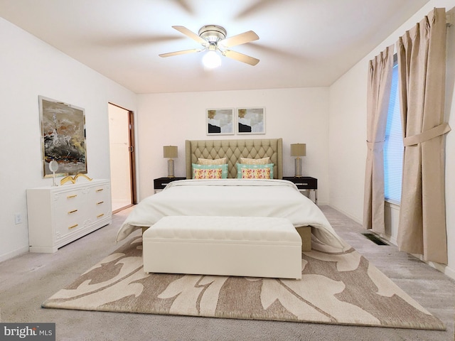 bedroom with a closet, ceiling fan, and light colored carpet