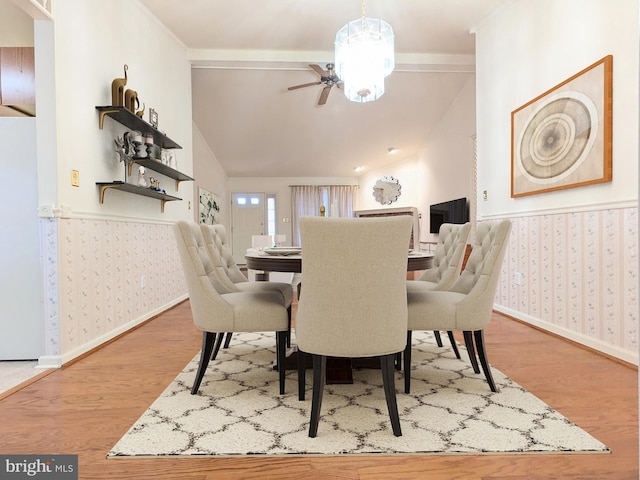 dining room with hardwood / wood-style floors and lofted ceiling