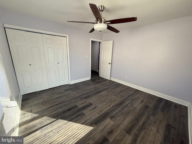 unfurnished bedroom featuring ceiling fan, dark wood-type flooring, and a closet