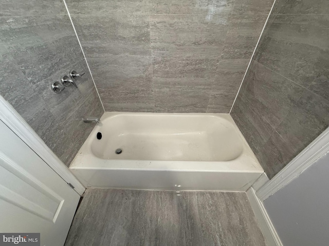 bathroom featuring hardwood / wood-style flooring and shower / tub combination