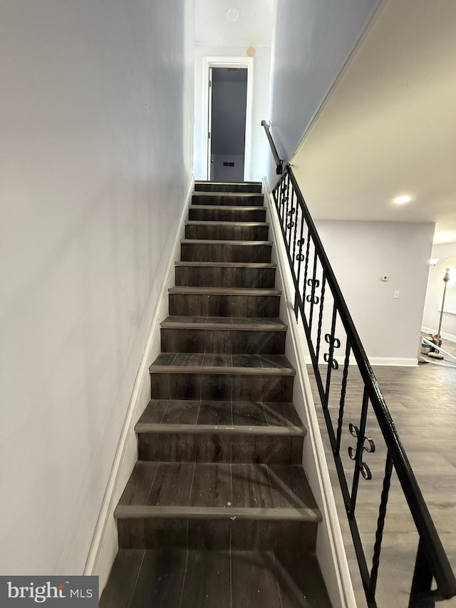 stairway featuring hardwood / wood-style flooring