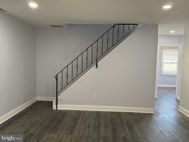 stairs featuring hardwood / wood-style floors