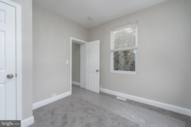 unfurnished bedroom featuring light carpet