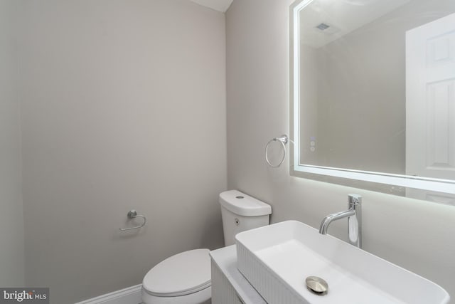 bathroom featuring toilet and vanity